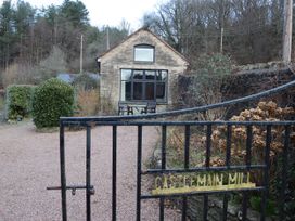 An exterior view of Castlemain Mill with table and chairs in Parkend