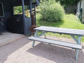 An outdoor space with a picnic table and a barbecue grill at Castle Rag in Parkend