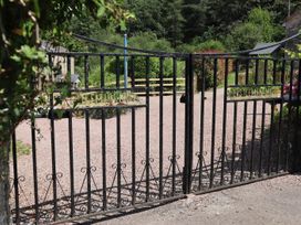 A gated entrance with a sign at Castle Rag in Parkend