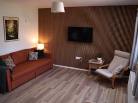 A living room with a sofa and television at Castle Rag in Parkend