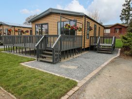 A cabin with a deck and planter boxes at Tulip in Eardisland