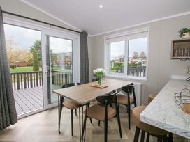 A dining room with a table and chairs at Tulip in Eardisland