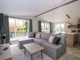 A living room with a sofa and table at Tulip in Eardisland