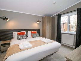 A bedroom with a bed and wardrobe at Tulip in Eardisland