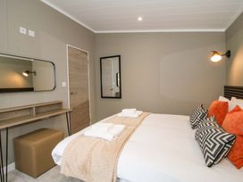 A bedroom with a bed and dressing table at Tulip in Eardisland