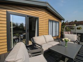 An outdoor seating area with a table and chairs at Tulip in Eardisland