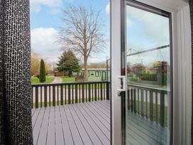 A view from a door onto a deck area at Poppy in Eardisland