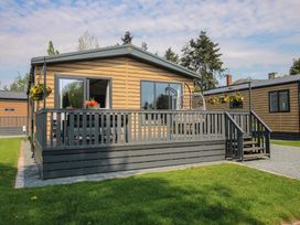 A house with a deck and flower pots at Poppy in Eardisland