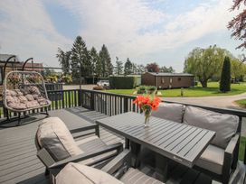 A patio with a table and chairs at Poppy in Eardisland