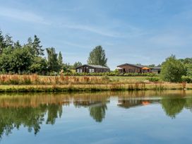 A view of houses by a pond at Poppy in Eardisland