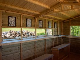An indoor space with wooden walls and benches at Poppy in Eardisland