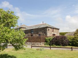 A stone building with a wooden fence at Applestore in Wadebridge