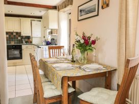 A dining room with a table and chairs at Applestore in Wadebridge