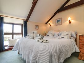 A bedroom with a large bed and window at Applestore in Wadebridge