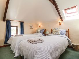 A bedroom with two beds and curtains at Applestore in Wadebridge