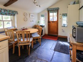 A kitchen with a table and chairs at Beckside Studio Penrith