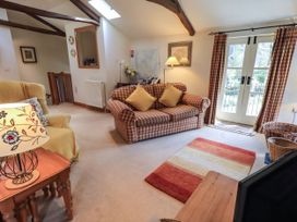 A living room with a couch and armchair at Beckside Studio in Penrith