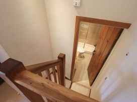 A staircase leading to a bathroom with a toilet and shower at Beckside Studio in Penrith