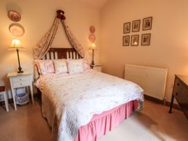 A bedroom with a bed and nightstands at Beckside Studio in Penrith