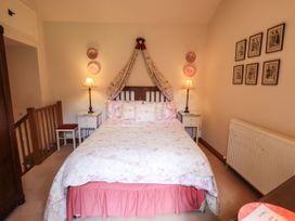 A bedroom with a bed and bedside tables at Beckside Studio in Penrith