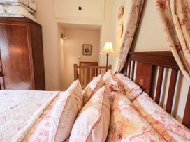 A bedroom featuring a bed with pillows and a wardrobe at Beckside Studio Penrith