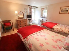 A bedroom with two beds and a television at Beckside Studio in Penrith