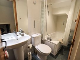 A bathroom with a bathtub and wash basin at Beckside Studio in Penrith