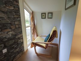 A snug area with a chair and window at Beckside Studio in Penrith