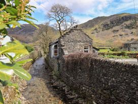 A stone building beside a stream in a rural setting at Beckside Studio Penrith