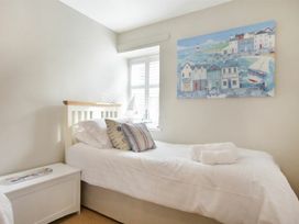 A bedroom with two beds and wall art at Juniper Cottage