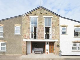 An outdoor view of a building with a balcony at Juniper Cottage in 