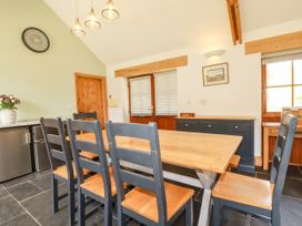 A kitchen with a table and chairs at Little Trethellan in Trethellan near Lanner