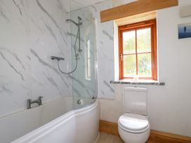 A bathroom with a bathtub and shower at Little Trethellan in Trethellan near Lanner