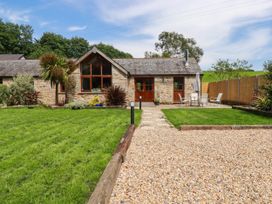 An outdoor area with a house, patio furniture and lawn at Little Trethellan in Trethellan near Lanner