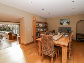 A dining room with a large table and chairs at Awelon Y Mor in Aberaeron