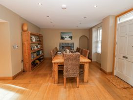 A dining room with a table and chairs at Awelon Y Mor in Aberaeron