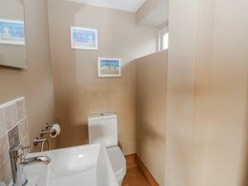 A bathroom with a sink and toilet at Awelon Y Mor Aberaeron