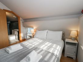 A bedroom with a bed and bedside table at Awelon Y Mor in Aberaeron