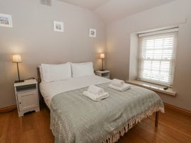 A bedroom with a bed and bedside tables at Awelon Y Mor in Aberaeron