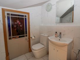 A bathroom with a toilet and sink at Awelon Y Mor in Aberaeron