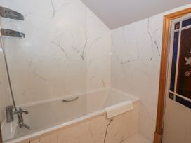 A bathroom with a bathtub and shower at Awelon Y Mor in Aberaeron
