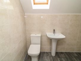 A bathroom with a toilet and sink at Ruby Red in Brigg