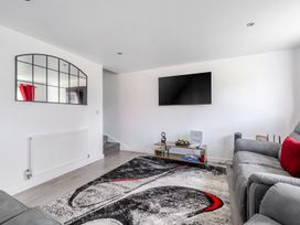 A living room with a sofa and television at Ruby Red Near Brigg
