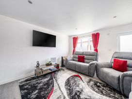 A living room with a sofa and TV at Ruby Red near Brigg