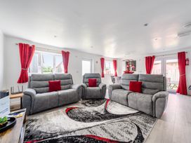A living room with sofas and large windows at Ruby Red near Brigg