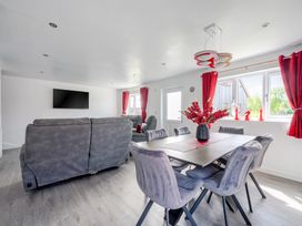 A living room with a sofa and dining table at Ruby Red near Brigg