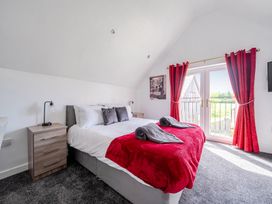 A bedroom with a bed and furniture at Ruby Red Near Brigg