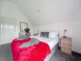A bedroom with a bed and bedside table at Ruby Red near Brigg