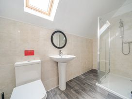 A bathroom with a toilet, wash basin, and shower at Ruby Red near Brigg