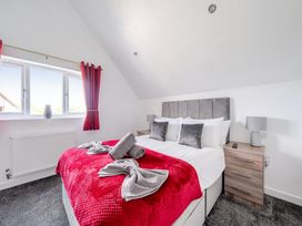 A bedroom with a bed and bedside tables at Ruby Red Near Brigg